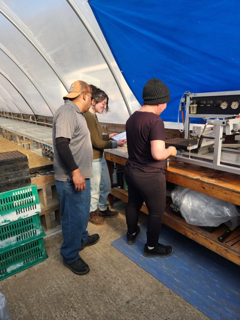 Mellissa, Gerardo, and Adelaida going over planting strategies for the day